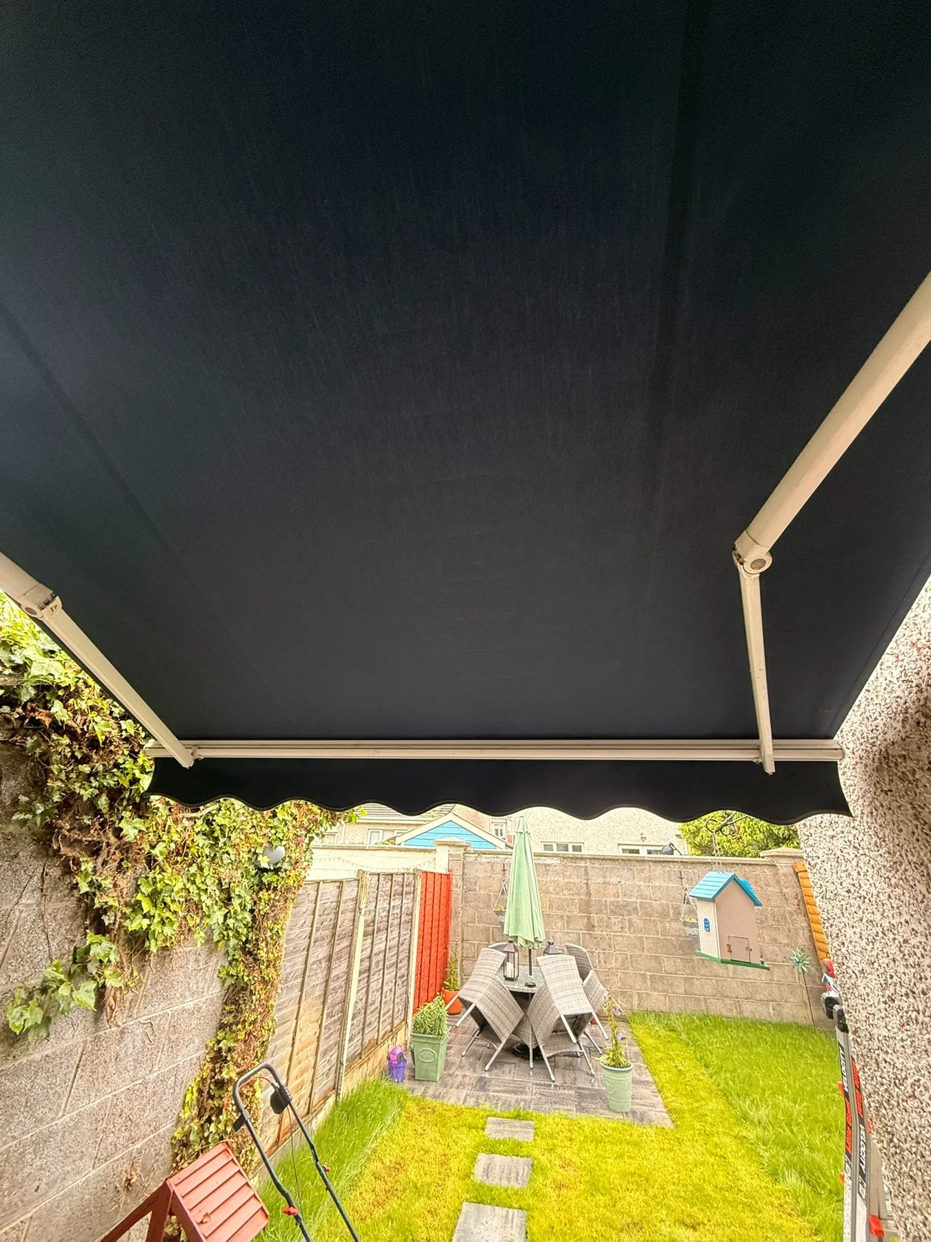 Dark replacement awning fabric viewed from underneath after servicing