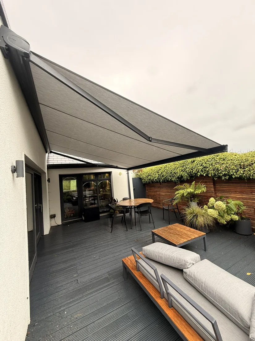 Slimline cassette awning shading a deck and outdoor dining area