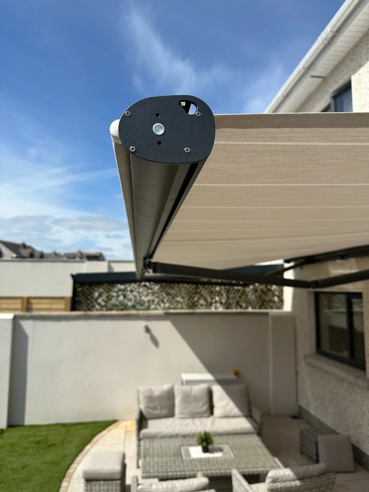 Light rollable front awning with a vertical screen providing extra low-angle sun shade