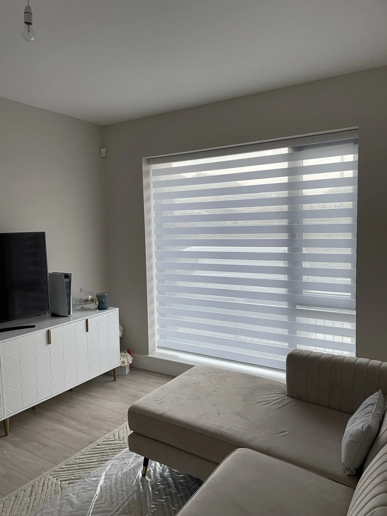 White Day and Night blind fitted in a contemporary living room