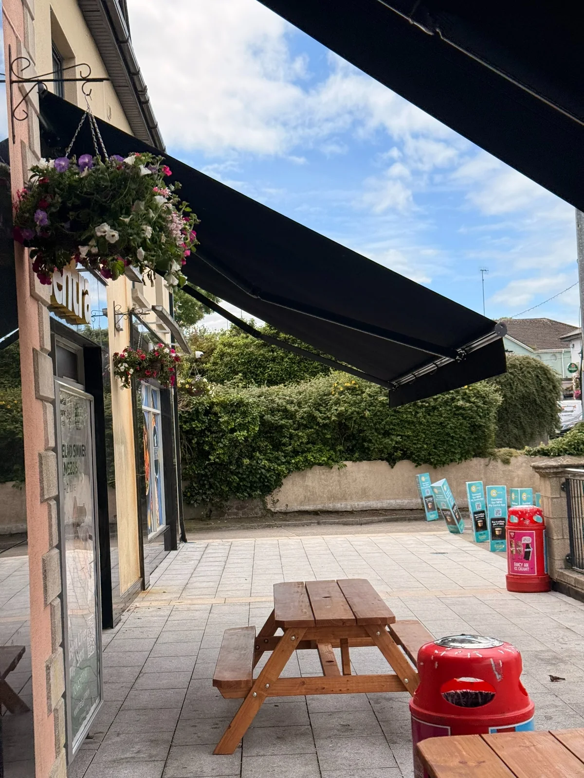 Black commercial awning viewed from the Frank and Honest outdoor seating area