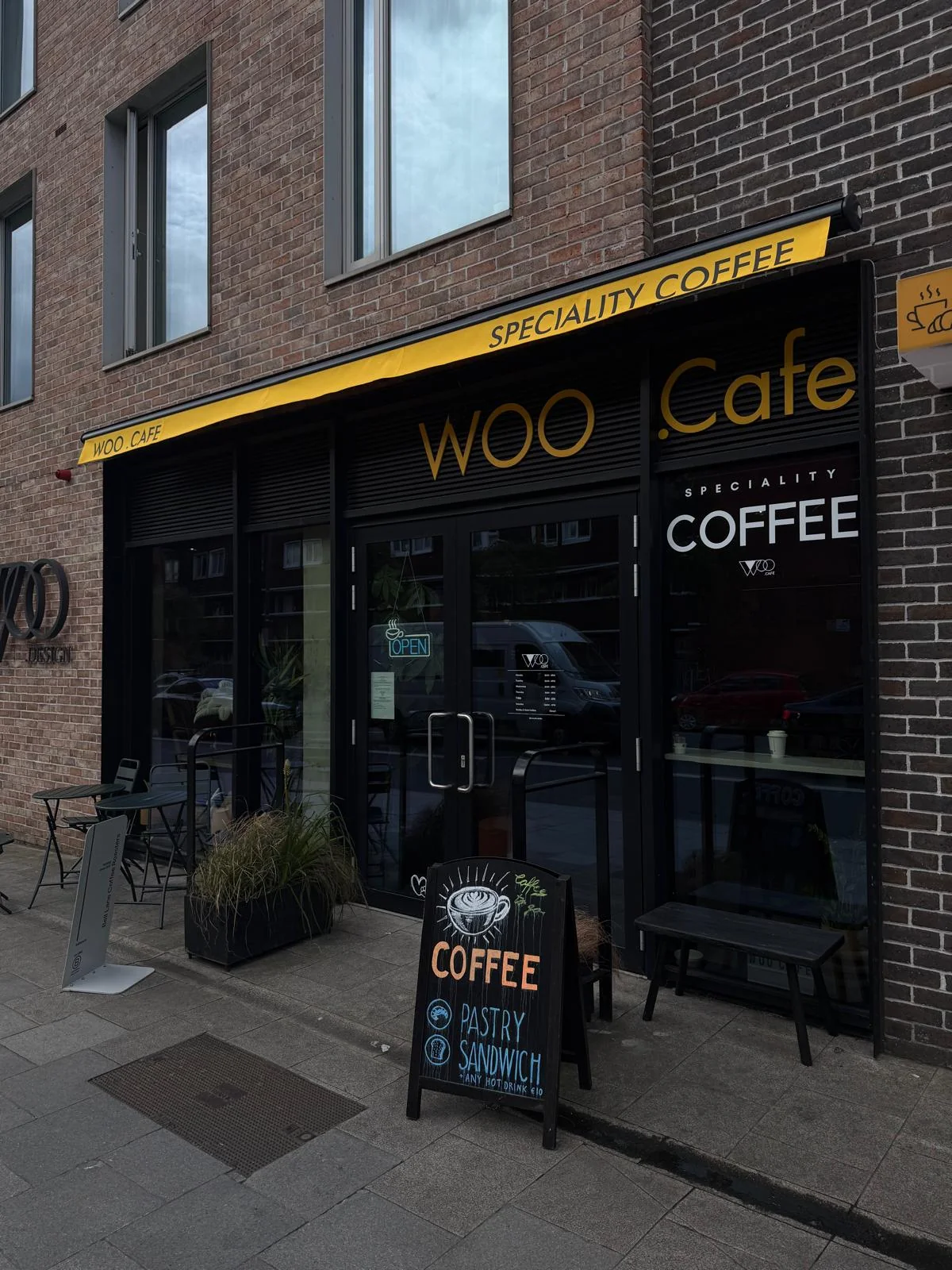 WOO CAFE shopfront with yellow branded commercial awning detail