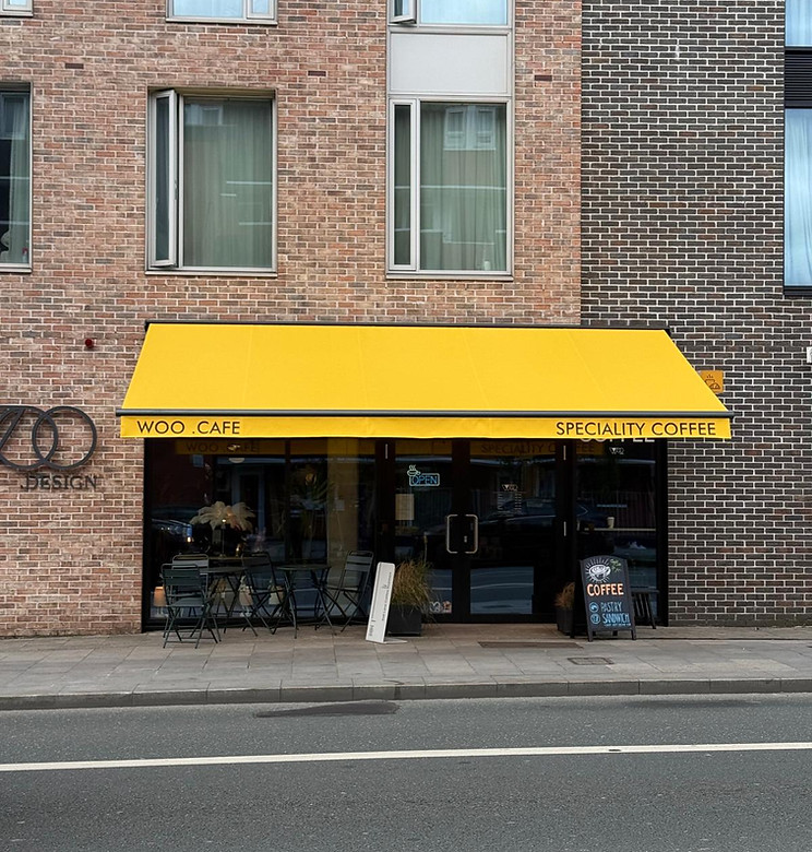 Yellow commercial awning fitted above a shopfront