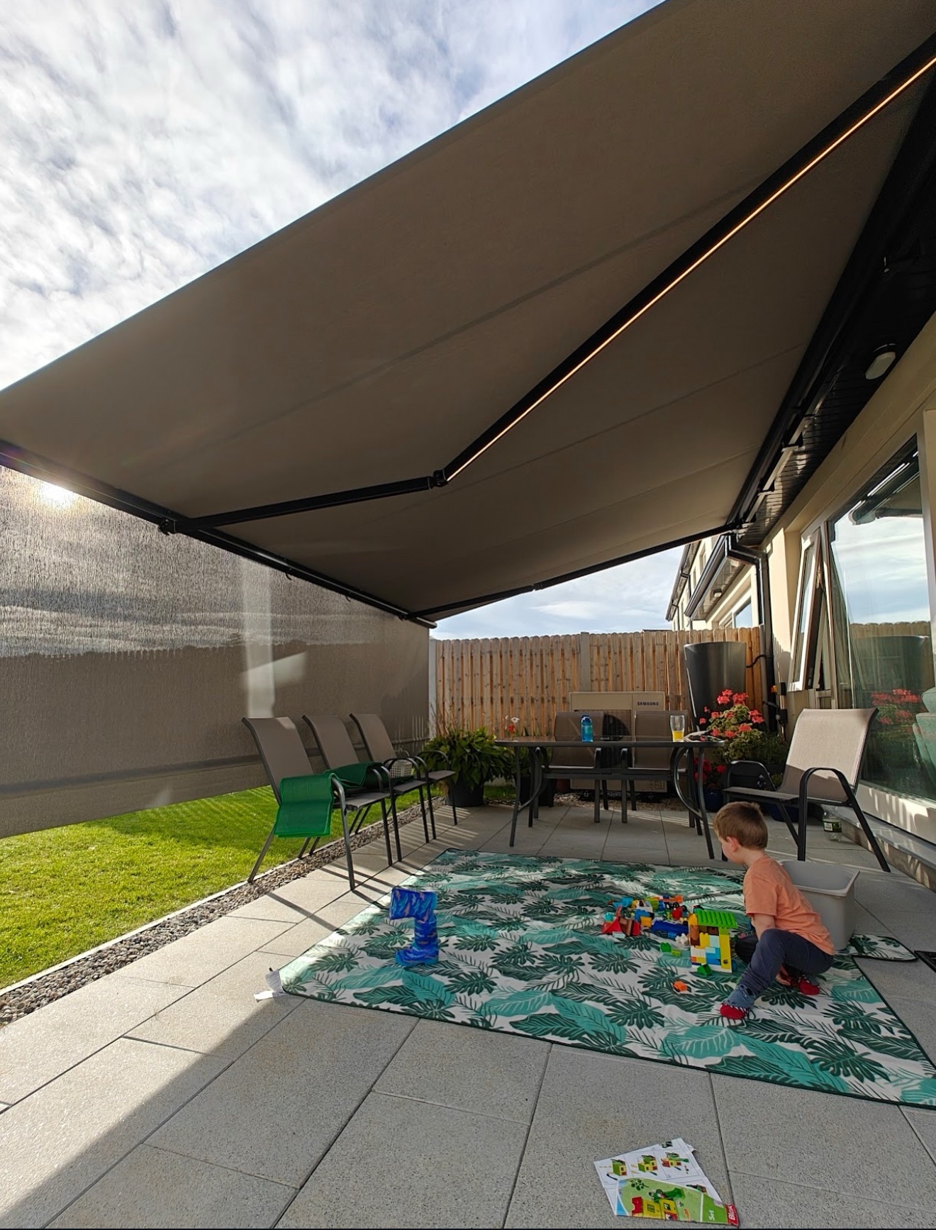 Retractable awning providing shade over an outdoor dining area
