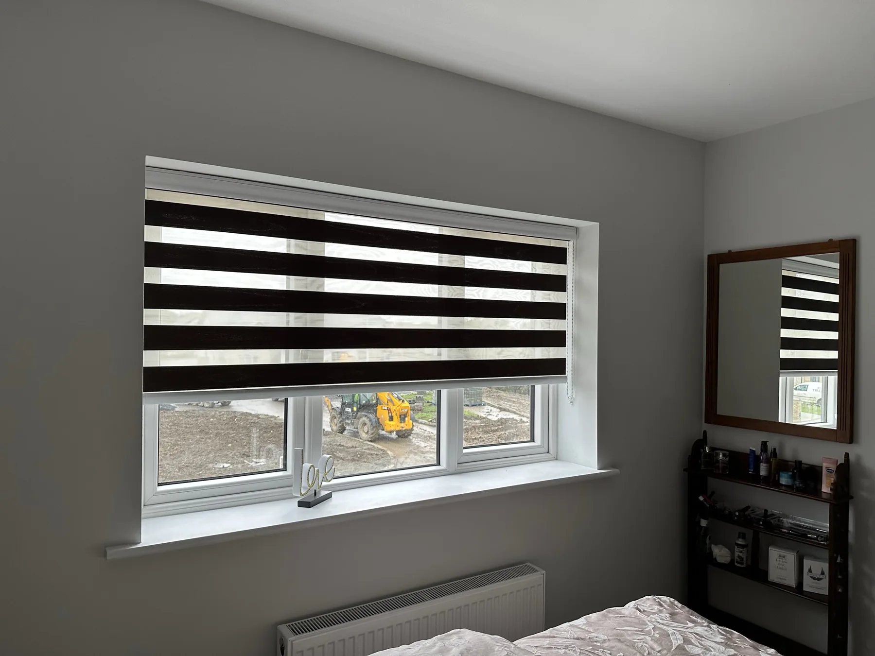 Dark day and night blind on a wide bedroom window