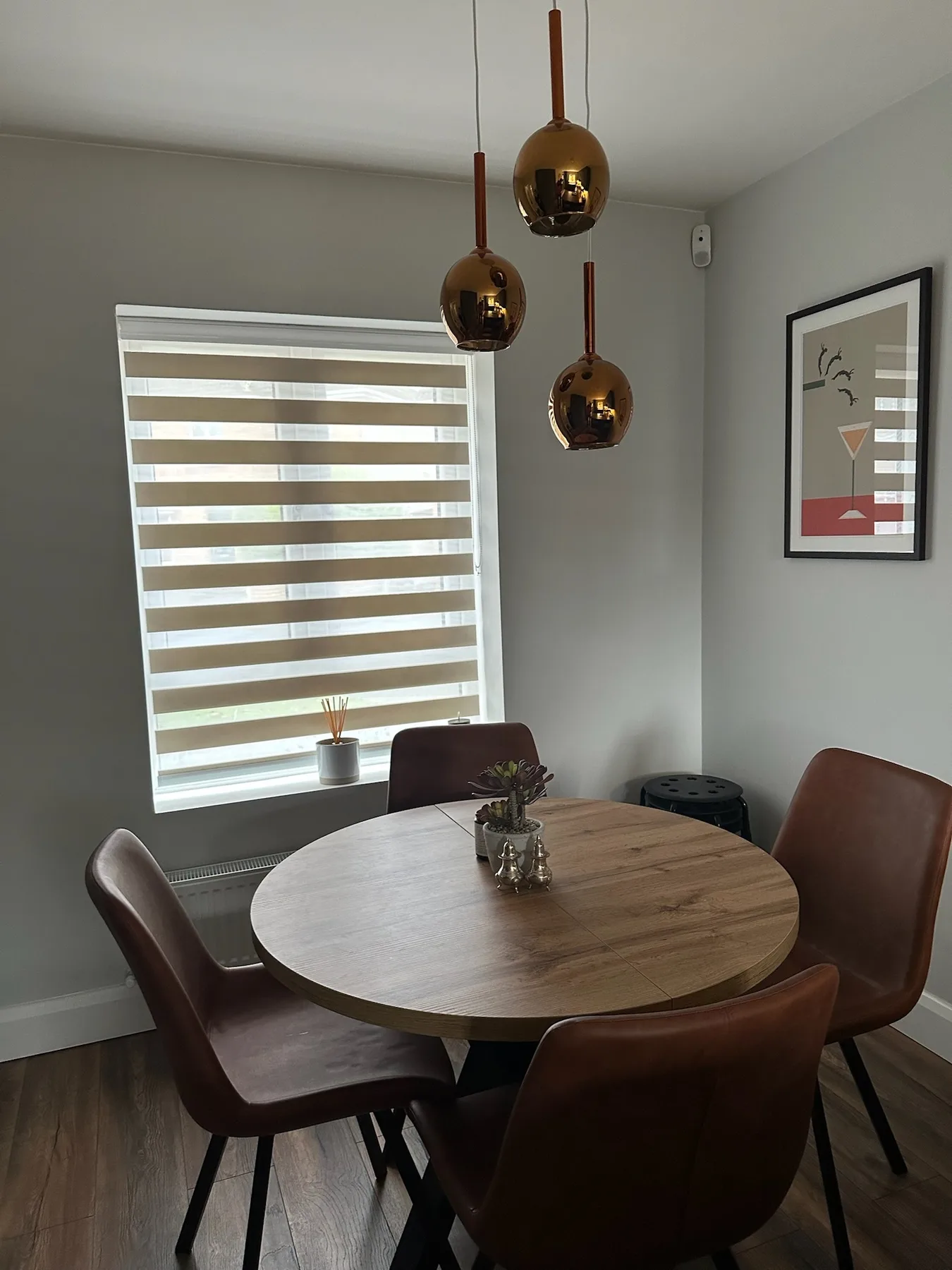 Neutral day and night blind beside a round dining table