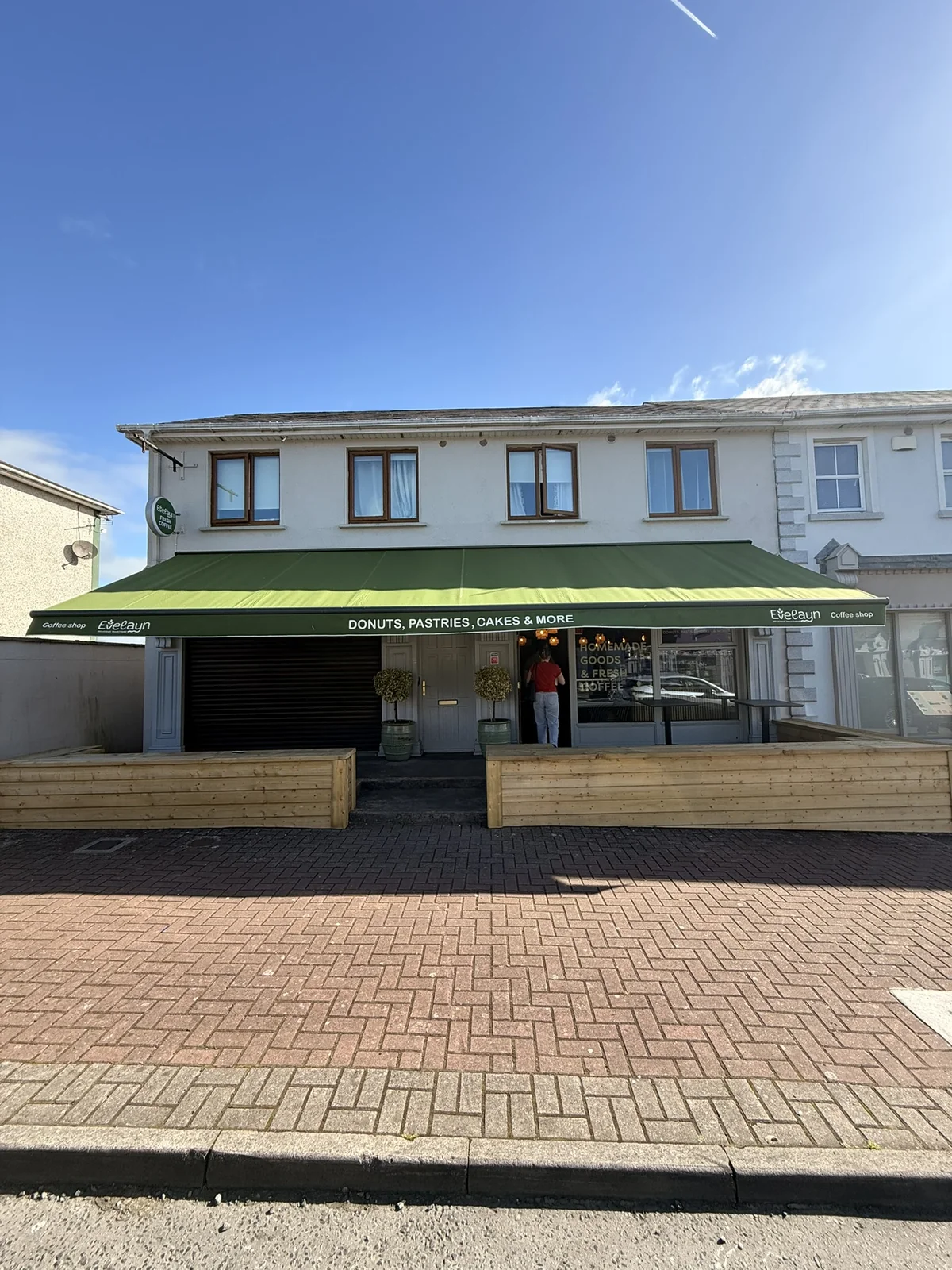 Commercial awning installed above a customer-facing coffee shop frontage
