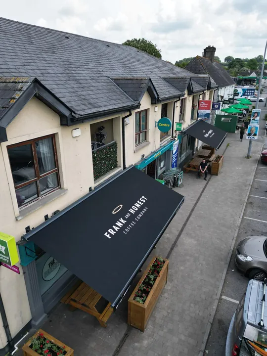 Branded commercial awning above a coffee shop frontage