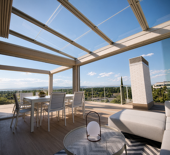 Glass roof pergola enclosing a bright residential patio