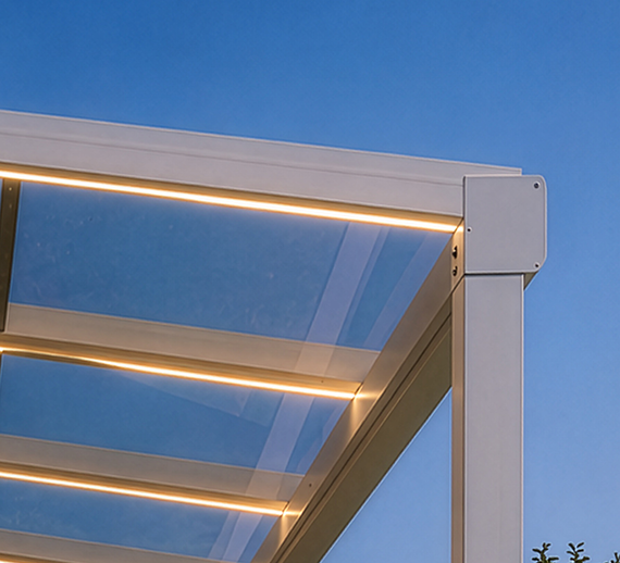Close-up of warm LED strips integrated into a glass pergola beam