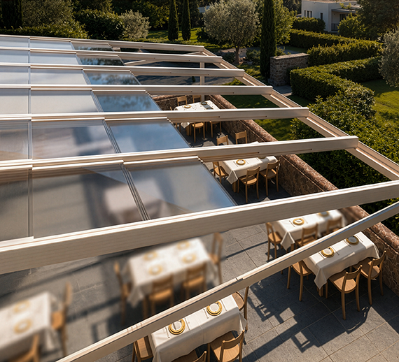 Retractable glass roof structure viewed from above a hospitality terrace