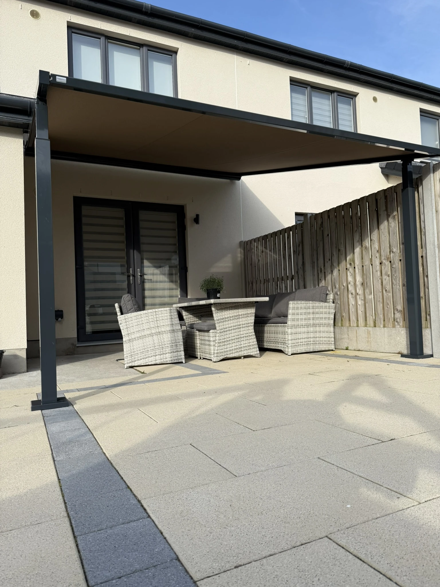 Outdoor seating area shaded by a hybrid pergola awning installation near Dublin