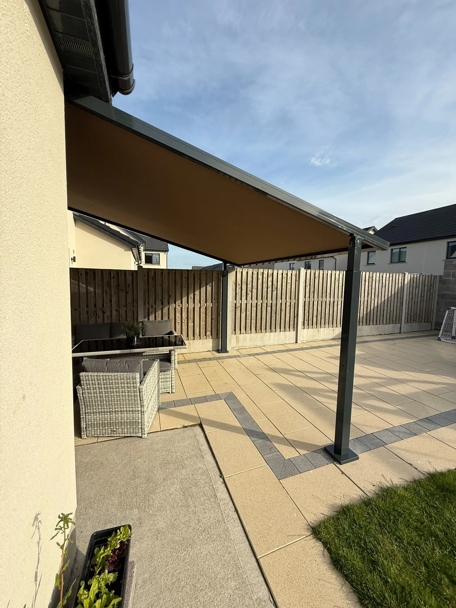 Side view of an aluminium hybrid pergola frame and fabric roof in an Irish garden