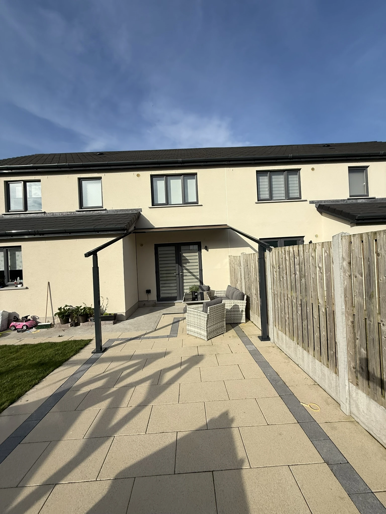 Hybrid pergola and awning fitted to a residential garden patio in the Dublin region