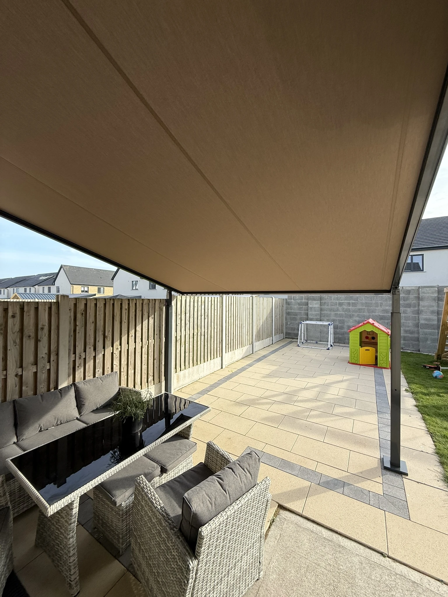View from beneath a retractable fabric roof on a hybrid pergola in Ireland