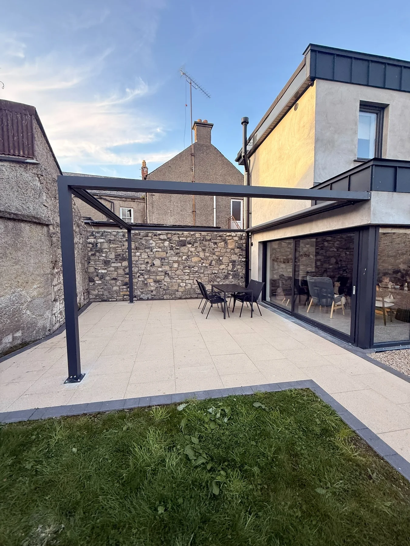 Pergola Square aluminium frame during installation beside a residential property