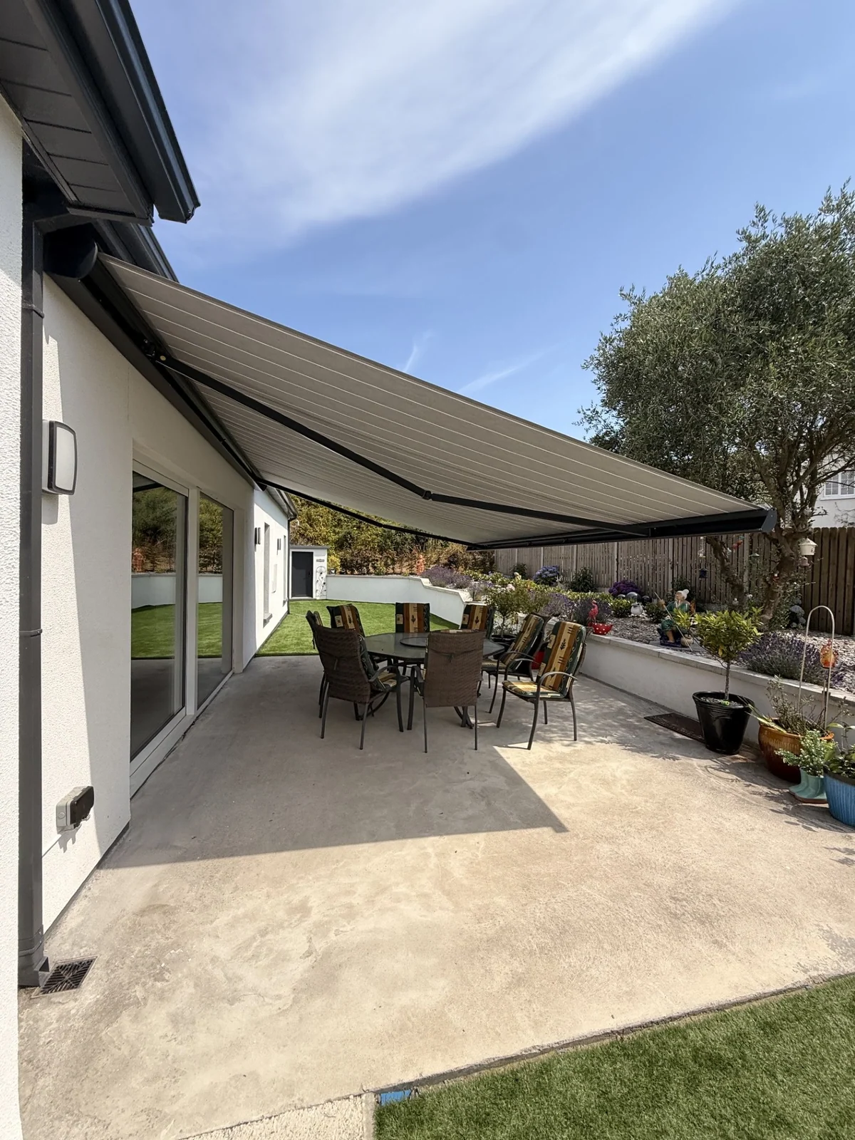View beneath an extended PRO awning over a patio dining table