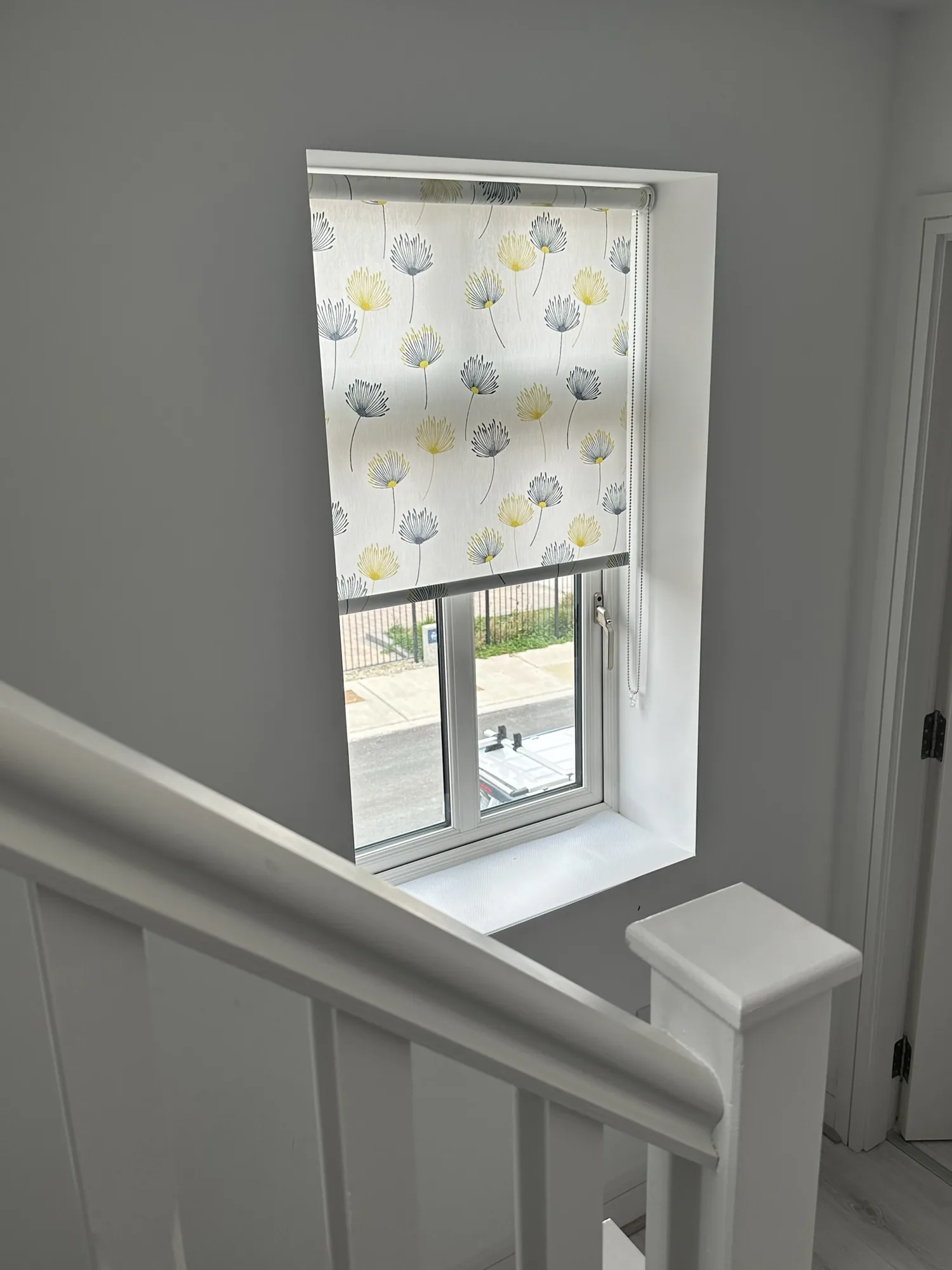 Patterned roller blind fitted to a stair window in Ireland