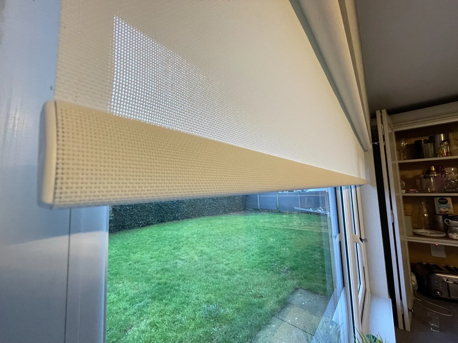 Close-up of light-filtering roller blind fabric showing the woven texture