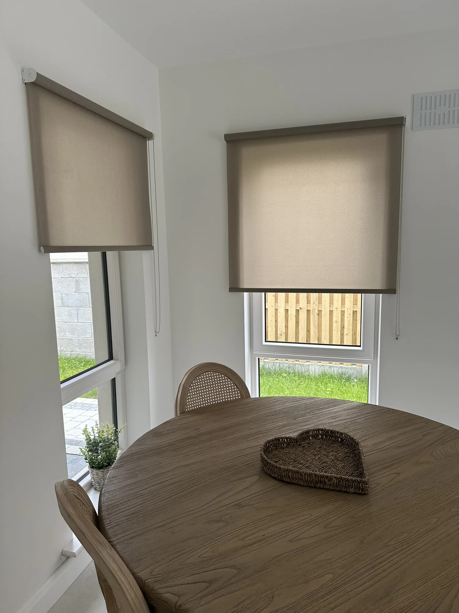 Natural taupe roller blinds in a bright dining area