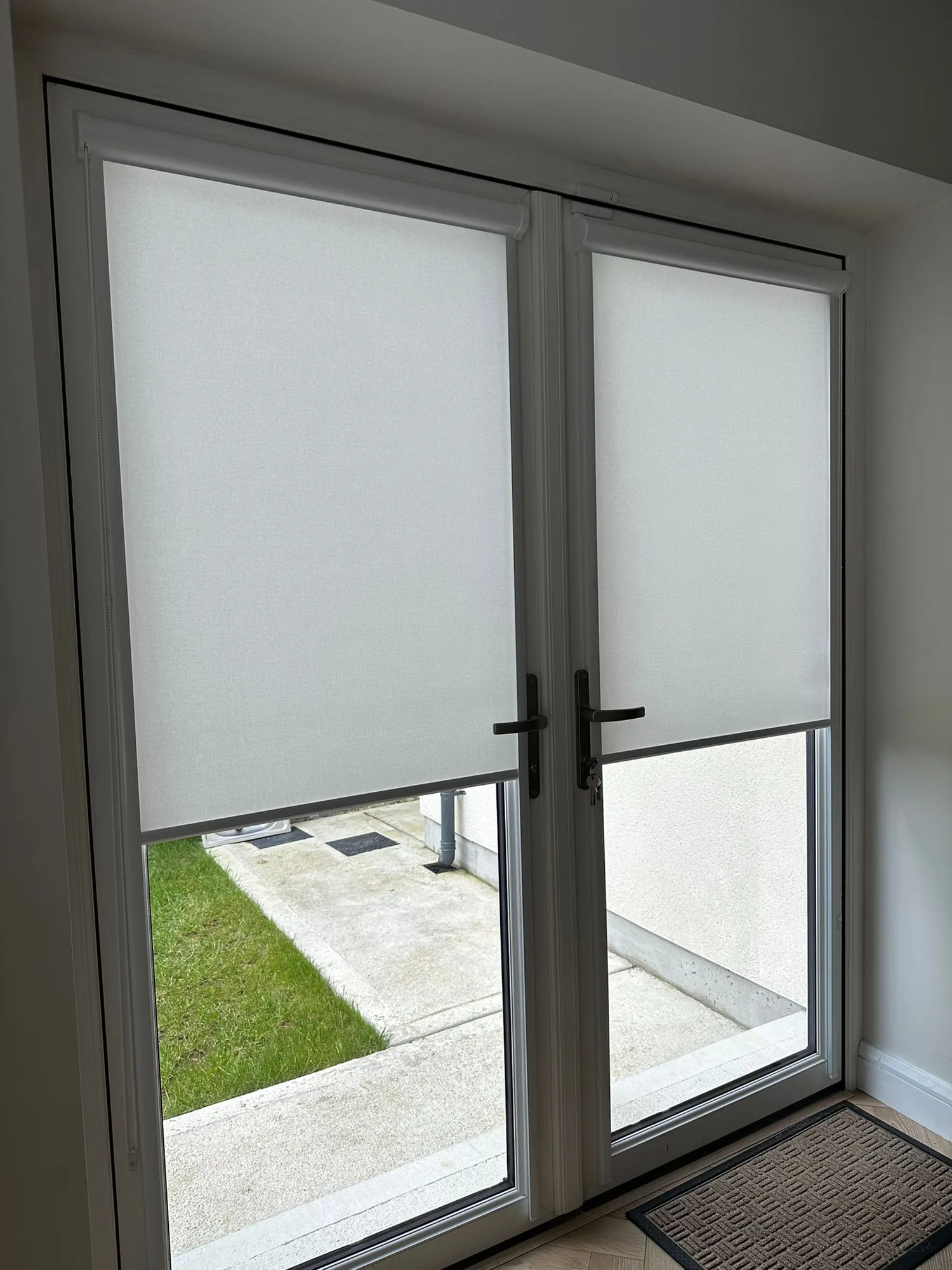 White roller blinds fitted to French doors