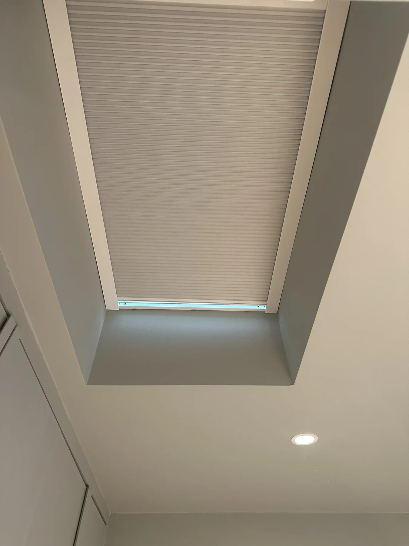 Pleated roof blind fitted neatly within a deep skylight recess