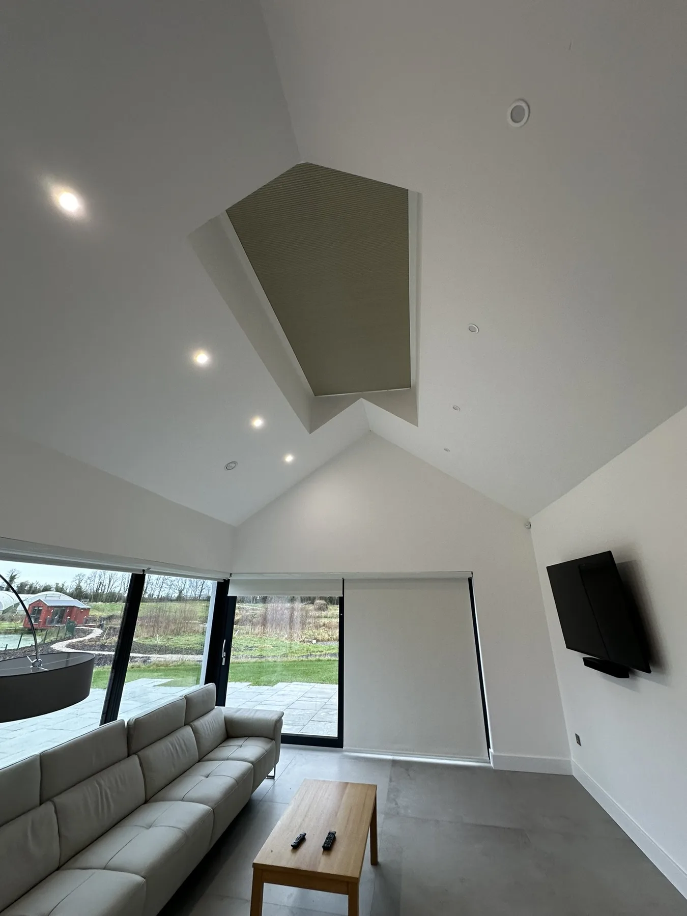 Pleated skylight blind closed neatly within a vaulted ceiling opening