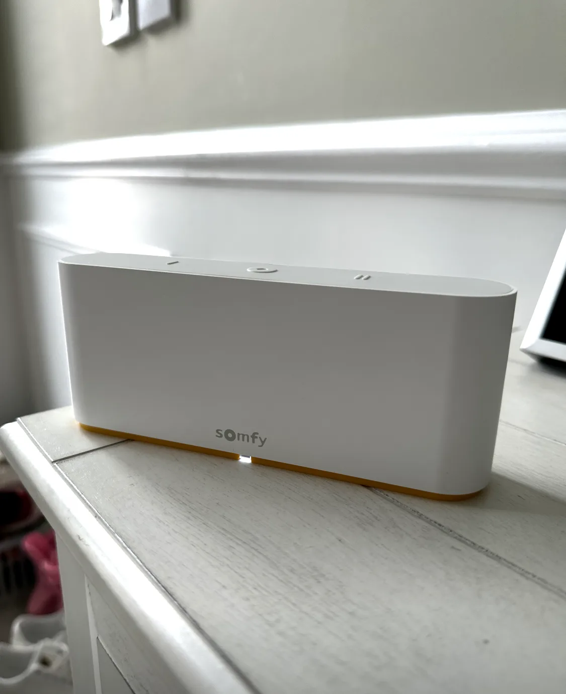 Somfy TaHoma switch hub on a cabinet in a home