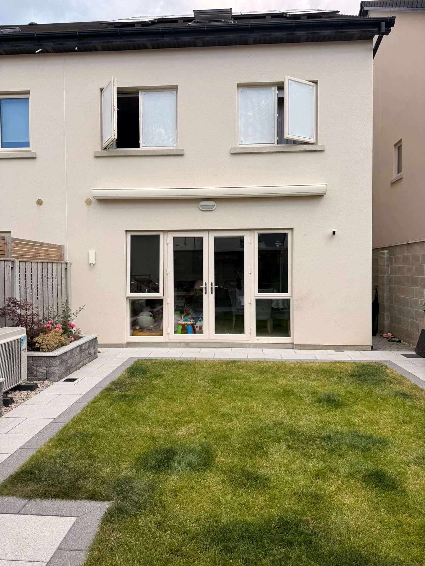 Full cassette awning fully retracted into its closed cassette above patio doors