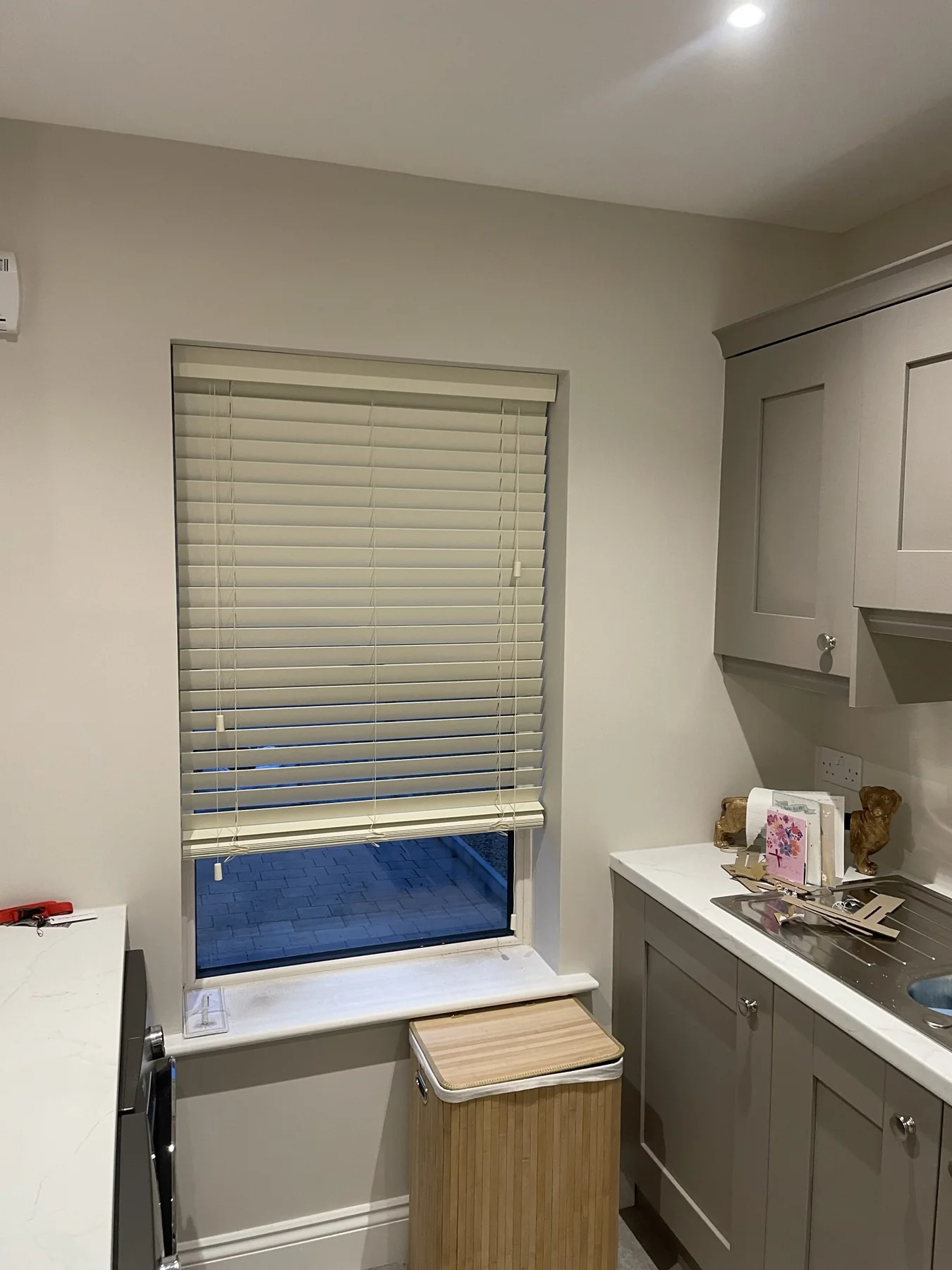Grey Venetian blind fitted to a tall kitchen window