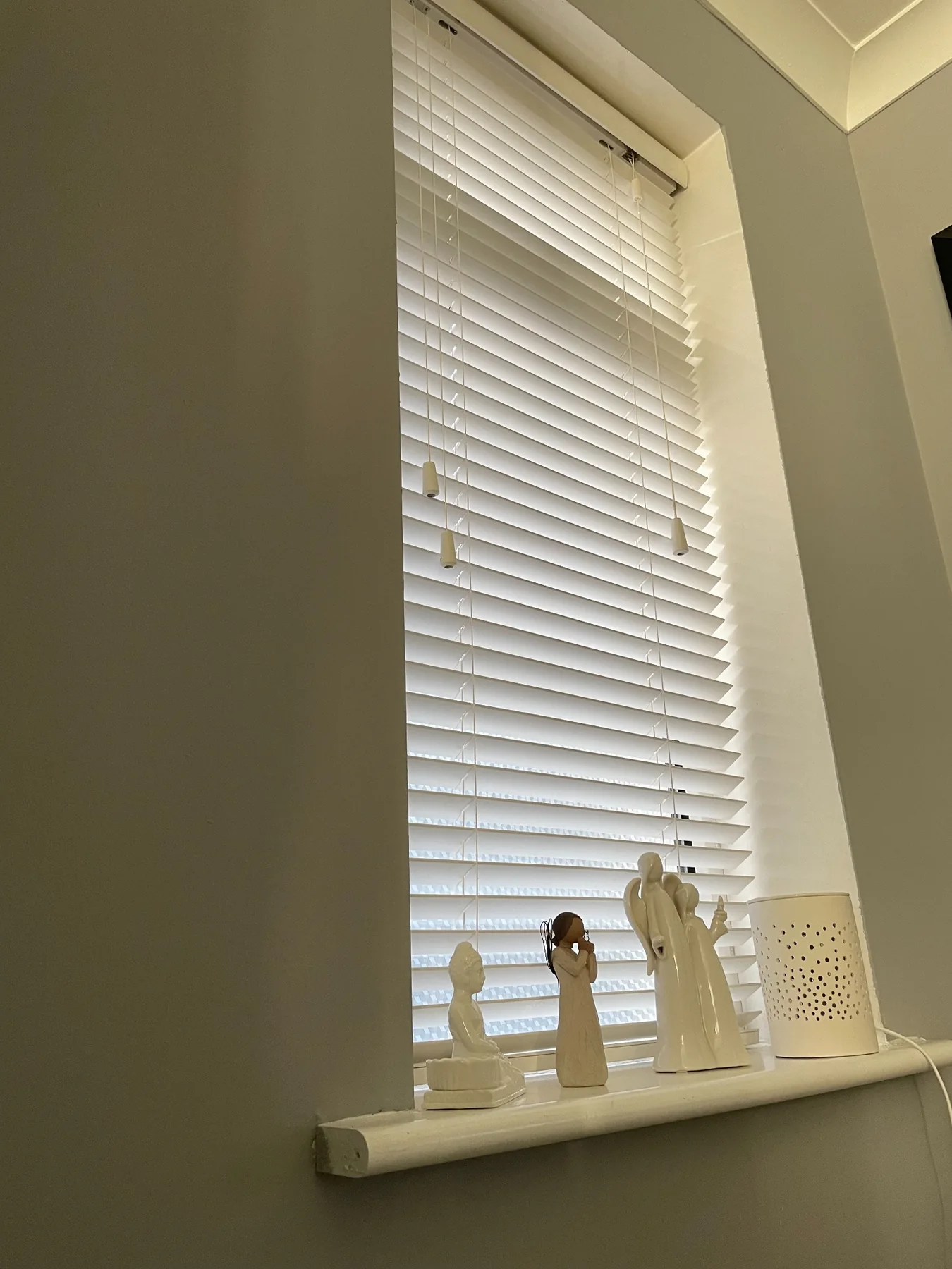White Venetian blinds in a bright dining area