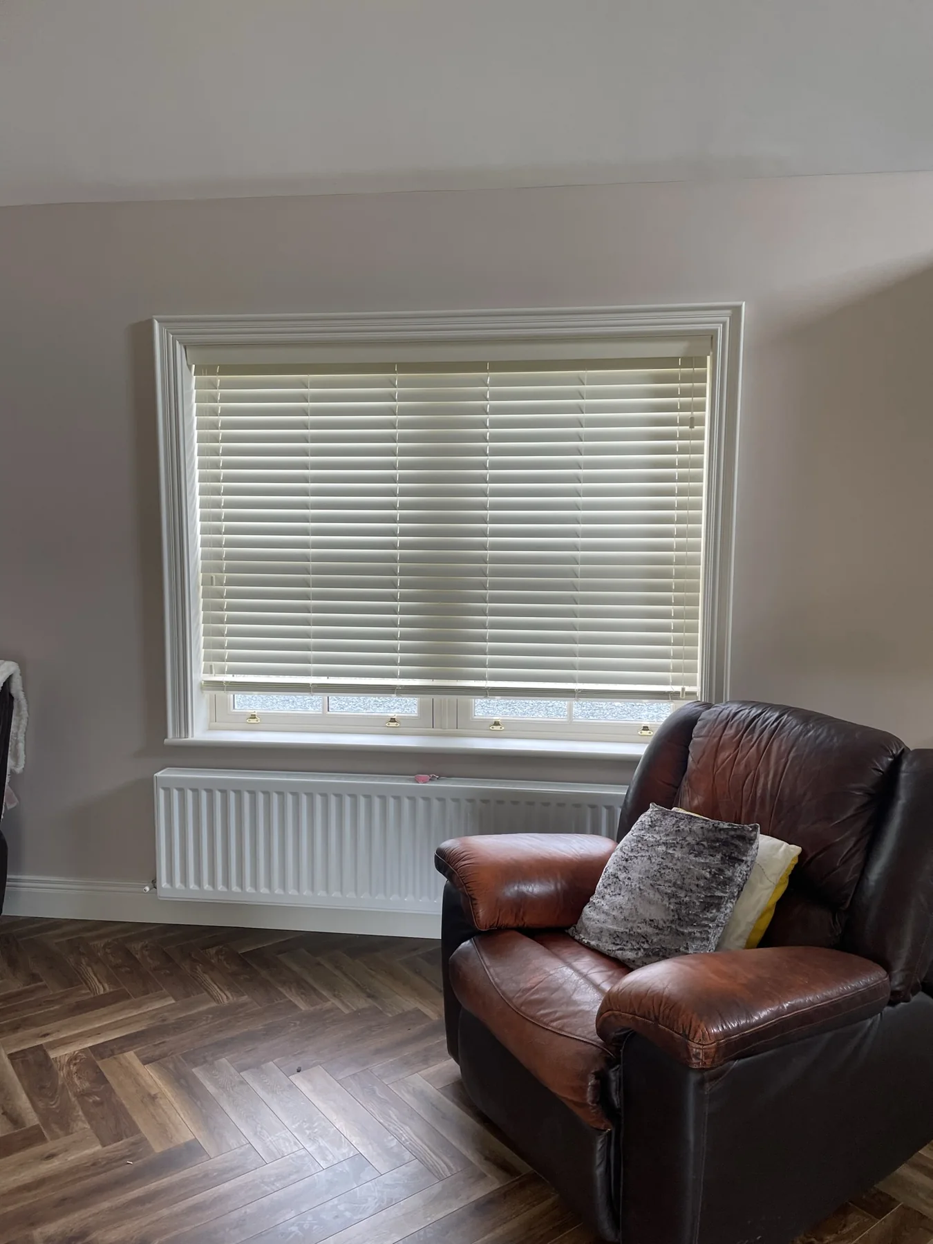 White Venetian blinds fitted in a kitchen with cream cabinetry