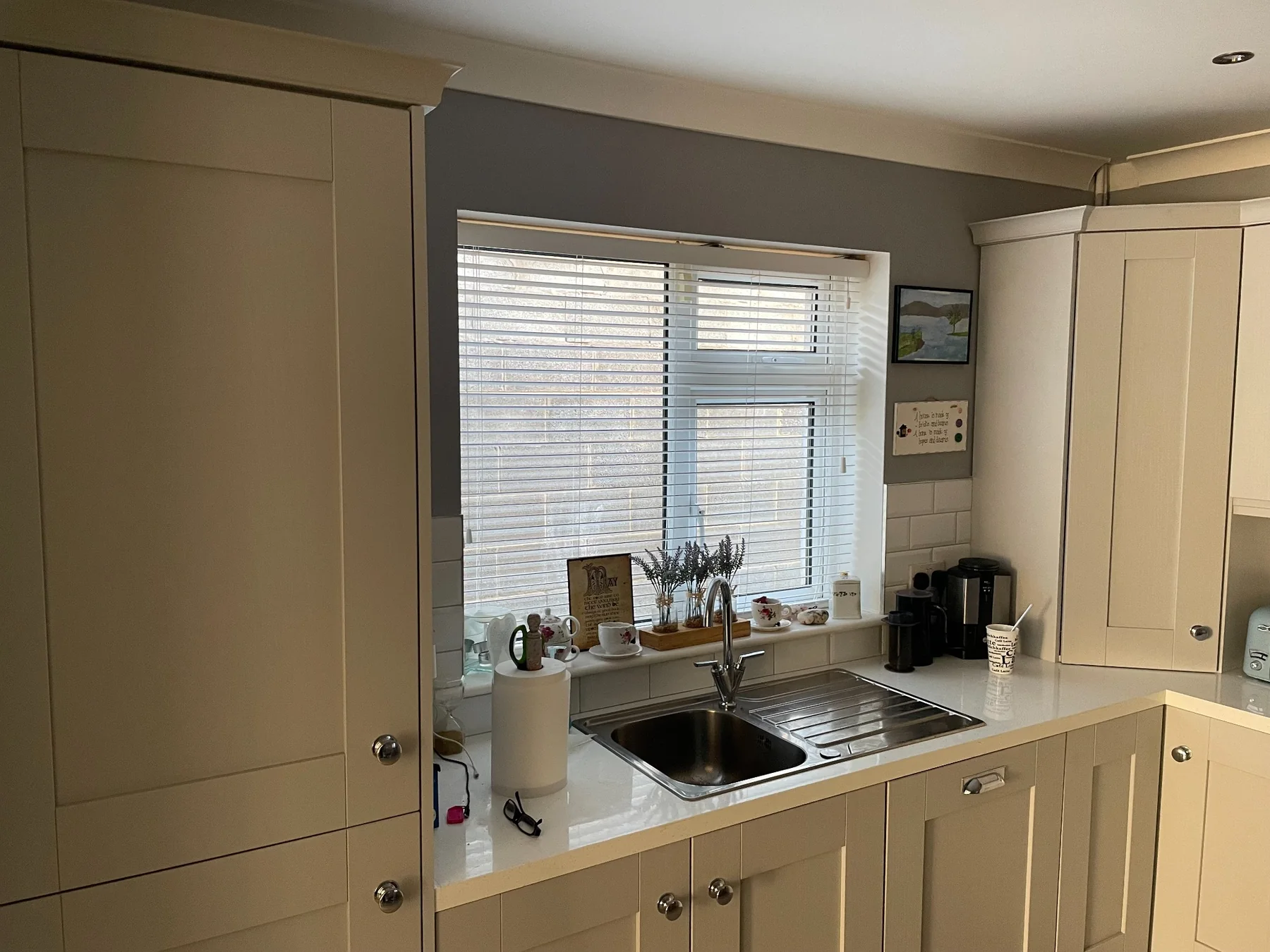 Wide white Venetian blind fitted in a modern kitchen