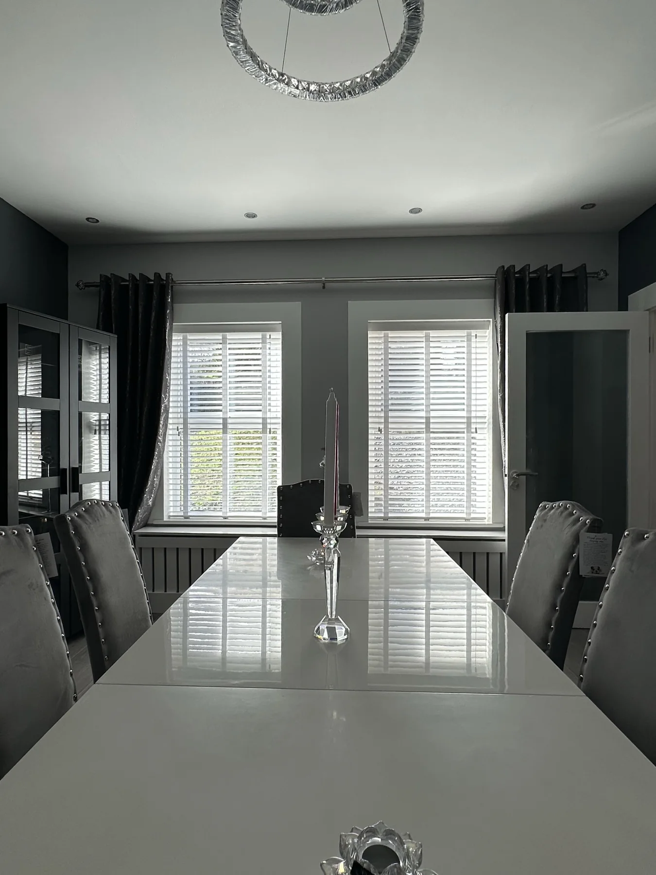 White Venetian blind fitted in a living room with an armchair